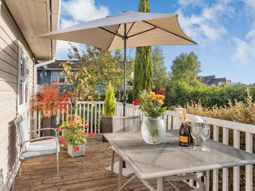 a patio with a table and an umbrella at Beech Tree Lodge in Willington