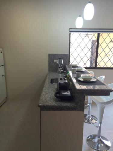 a kitchen with a counter top with a sink and a counter top at NCG Suite in Guayaquil