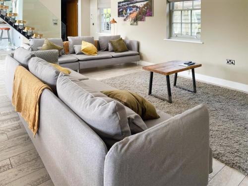 a living room with a couch and a table at Ivy Cottage in Beck Hole