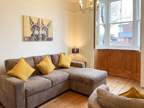 a living room with a couch and a window at Station House in Hornsea