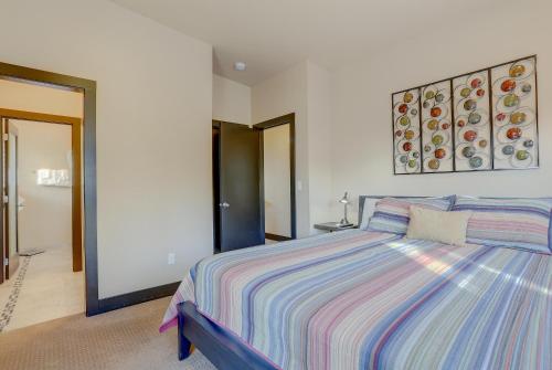 a bedroom with a bed with a striped comforter at Urban Roundabout in Bend