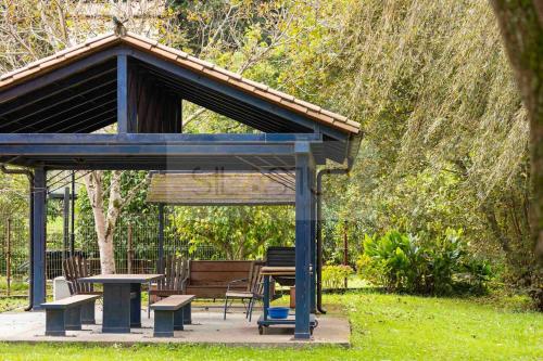 a gazebo with a picnic table and a bench at Casa Sildavia By Silastur in La Riera