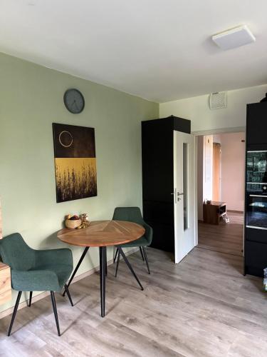 a dining room with a table and chairs at Modern Apartment in a Leafy Town Close to Prague 