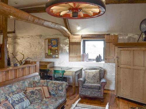 a living room with a couch and a table at The Old Sheaf Store - Kyz in Glaisdale