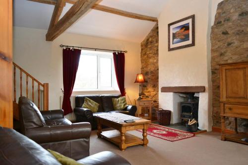 a living room with a couch and a table at Netherend in Threlkeld