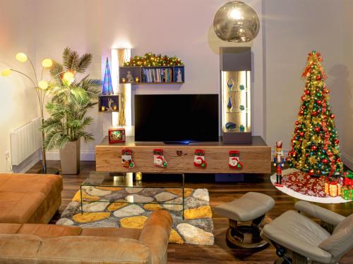 a living room with a christmas tree and a television at The Haven in Scarborough