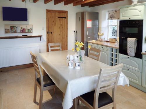 a kitchen with a table and chairs in a kitchen at The Old Chapel in Aysgarth