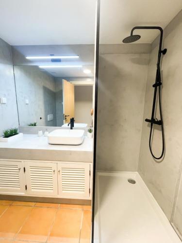 a bathroom with a sink and a shower at Luxury Apartment in Vila Sol Resort in Quarteira