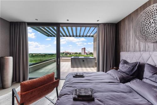 a bedroom with a bed and a large window at Villa Visignano with private pool, BBQ and jacuzzi in Strpačići