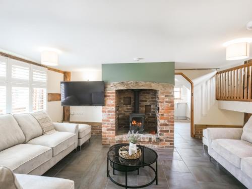 a living room with a couch and a fireplace at Uk46589 - Kibble in Church Stretton