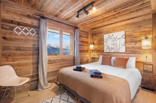 a bedroom with wooden walls and a bed and a window at Silverfox - 6 pers - belle vue in Plan Fey