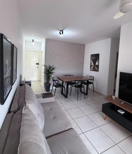 a living room with a couch and a table at Gran Apartamento com Piscina - 3 Quartos in Cuiabá
