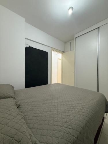 a bedroom with a bed and a blackboard on the wall at Gran Apartamento com Piscina - 3 Quartos in Cuiabá