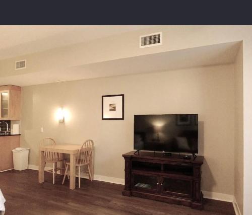 a living room with a table and a flat screen tv at Bahia Sandestin Golf and Beach Resort in Destin