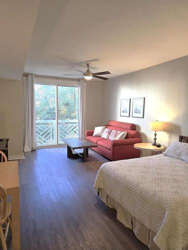 a bedroom with a bed and a red couch at Bahia Sandestin Golf and Beach Resort in Destin
