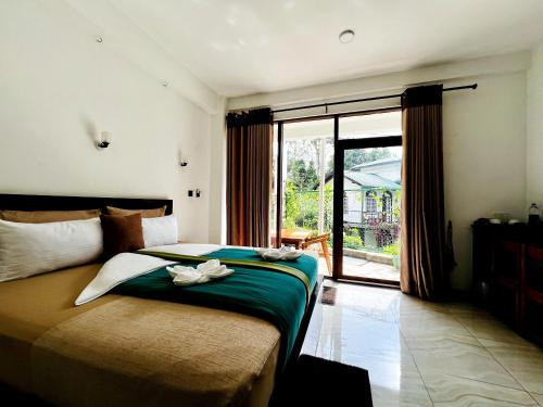 a bedroom with a bed and a large window at Eyeful Ella in Ella
