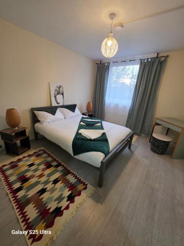 a bedroom with a large bed and a rug at Green &White Cozy 3-Bedroom in London