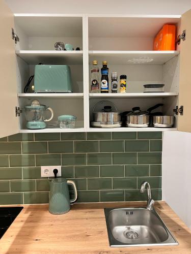 a kitchen with a sink and a counter top at Central Studio – Flor De Sol in Tavira