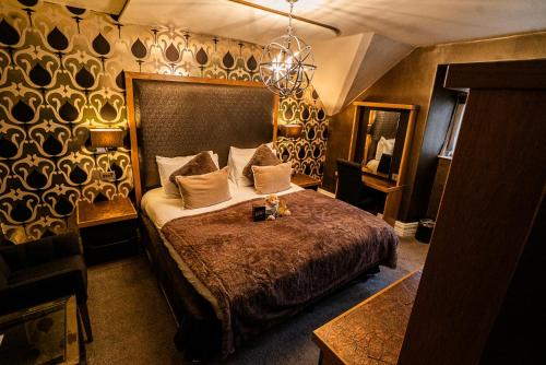 a bedroom with a large bed in a room at The Cranleigh Boutique in Bowness-on-Windermere