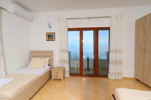 a bedroom with two beds and a view of the ocean at Hill Suites in Vlorë