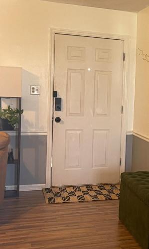 a white door with a rug in a living room at Simply Home in Statesboro