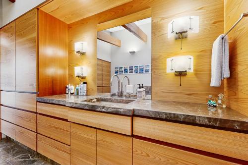 a bathroom with a sink and wooden walls at Rackliff Island Hideaway in Spruce Head