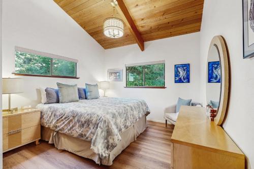 a bedroom with a bed and a dresser and a mirror at Sea Raven in Gualala