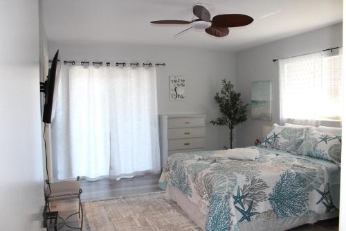 a bedroom with a bed and a ceiling fan at Blue Paradise in Englewood
