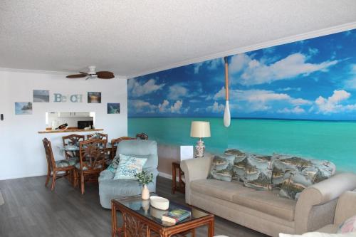 a living room with a mural of the ocean at Blue Paradise in Englewood