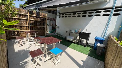 a patio with a table and chairs and a desk at WAKE UP @Lanta Hotel : Cafe in Ko Lanta
