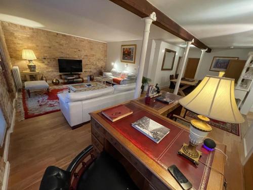 a living room with a couch and a table at The Old Seed Store in Stamford