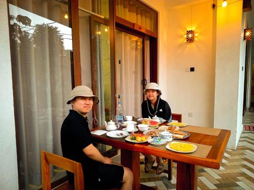 two people sitting at a table eating food at Eyeful Ella in Ella