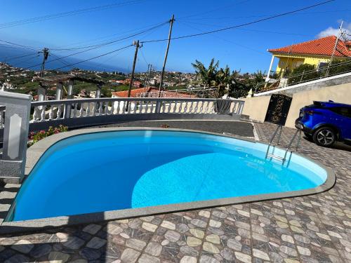a swimming pool in the backyard of a house at Slice of Ponta do Sol - Suite 2 in Canhas