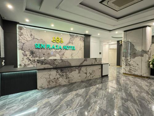 a lobby of a hotel with a sign on the wall at Sen plaza Hotel in Yên Thành