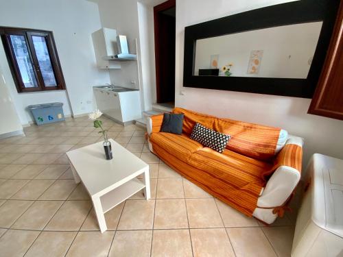 a living room with a couch and a table at Sardinian Gallery Corso in Bosa