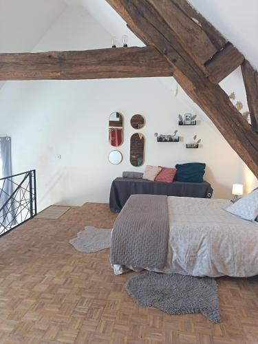 a bedroom with a bed in a attic at Loft Spa Prestige in Villampuy