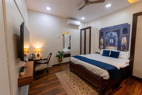 a bedroom with a king sized bed and a desk at Subah E Banaras in Varanasi