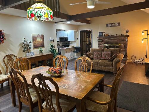 a dining room and living room with a table and chairs at WOW!! Ultimate Pocono Retreat, Hot Tub, Game Room, Deck, Lakes, Skiing, Pools in Long Pond