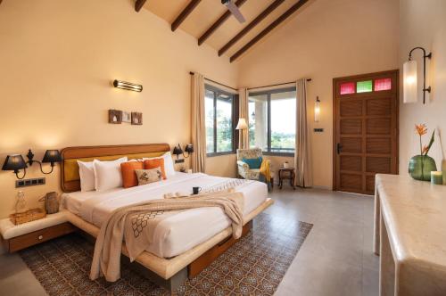 a bedroom with a large bed in a room at SaffronStays Maitri in Igatpuri
