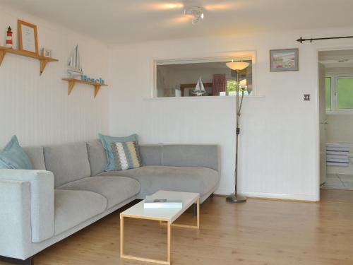 a living room with a couch and a table at Breakwater View in Turnchapel