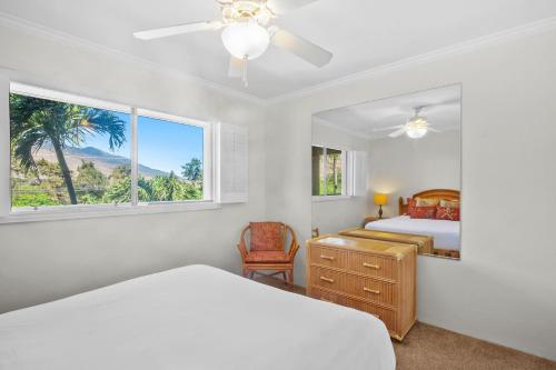 a bedroom with a bed and a window at Maalaea Kai 311 - Direct Ocean Front, Split AC in Wailuku