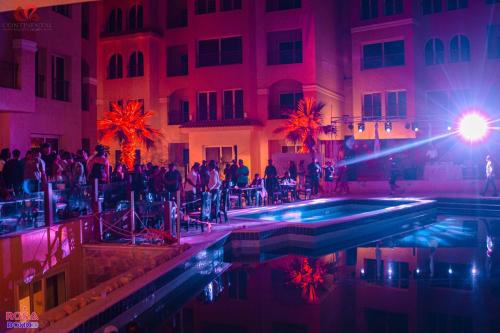 a group of people standing around a pool in a building at Rosa Boho Hotel And Aqua Park in Hurghada