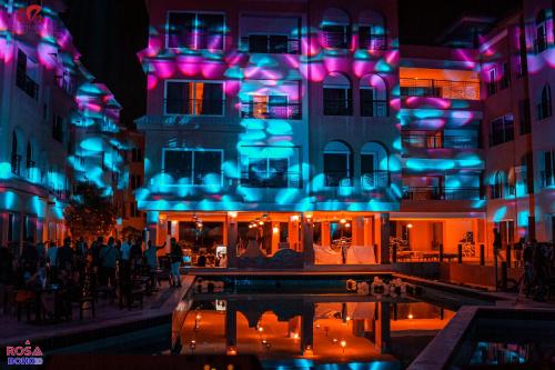 a building with blue and purple lights on it at Rosa Boho Hotel And Aqua Park in Hurghada
