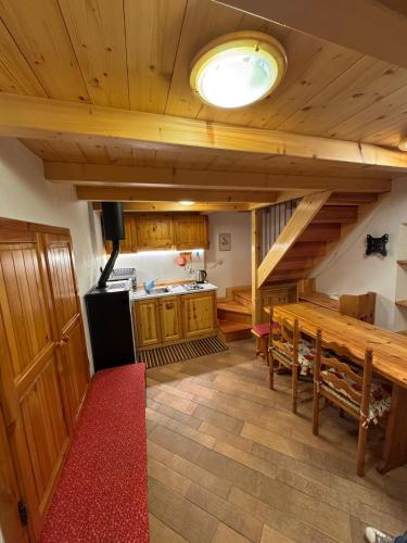 a kitchen with a wooden table and a counter top at La Casetta del Picchio in Caspoggio