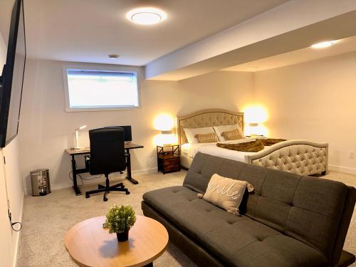 a living room with a couch and a bed at Cozy and Spacious Suite - Private Ensuit Bath - King Bed - Ultra Fast Wifi - Free Parking - Smart TV in Rockland
