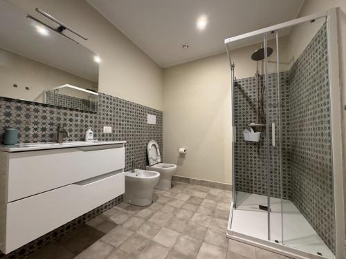 a bathroom with a toilet and a glass shower at Artop in Messina