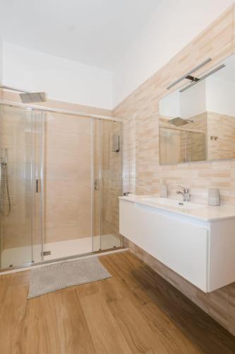 a bathroom with a white sink and a shower at IL CENTRO rooms in Cerignola