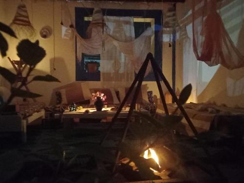 een woonkamer met een open haard voor een tafel bij Art Of Balance in Tamraght Ouzdar