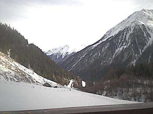 a snow covered mountain with a lake in the foreground at Wohnung Waldeslust In St Sigmund Im Sellrain in Sankt Sigmund im Sellrain