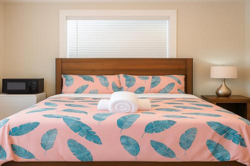 a bedroom with a pink bed with a stuffed animal on it at @ Marbella Lane Mini Guest House in Downtown San Jose in San Jose